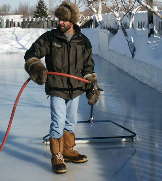 Man smoothing a backyard ice rink surface with a 52" NiceIce™ Resurfacer